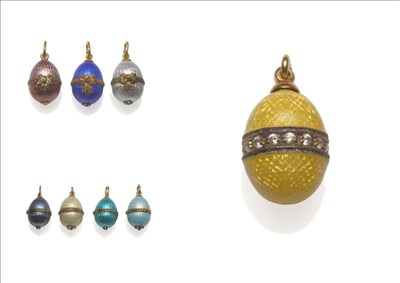 Lot 595 - Eight Russian Egg Pendants, enamelled in shades of blue, cream, white, pink and yellow, four...