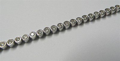 Lot 599 - An 18 Carat White Gold Diamond Line Bracelet, round brilliant cut diamonds in collet settings,...