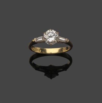 Lot 612 - An 18 Carat Gold Diamond Solitaire Ring, the round brilliant cut diamond between tapered...