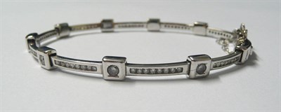 Lot 618 - A 9 Carat White Gold Diamond Bracelet, round brilliant cut diamonds in squared settings...