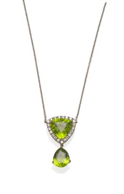 Lot 622 - An 18 Carat White Gold Peridot and Diamond Necklace, a triangular peridot within a border of...