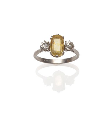 Lot 625 - A Yellow Sapphire and Diamond Three Stone Ring, an oval mixed cut sapphire between two round...