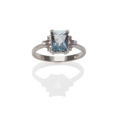 Lot 630 - An Aquamarine and Diamond Ring, the scissor cut aquamarine between shoulders of baguette cut...