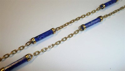 Lot 635 - An 18 Carat Gold Lapis Lazuli Necklace, faceted columns of lapis lazuli are spaced by sections...