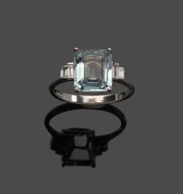 Lot 643 - An 18 Carat White Gold Aquamarine and Diamond Ring, an emerald-cut aquamarine with a pair of...