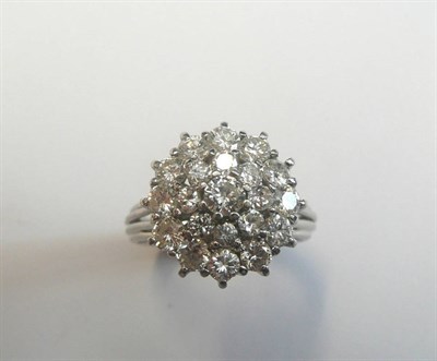 Lot 648 - A Diamond Cluster Ring, round brilliant cut diamonds in three rows, held in white claw settings, to