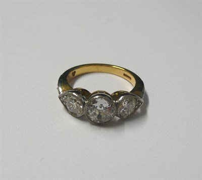 Lot 650 - An 18 Carat Gold Diamond Three Stone Ring, the brilliant cut diamonds in white millegrain settings