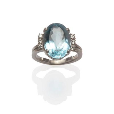 Lot 656 - An Aquamarine and Diamond Ring, an oval cut aquamarine with three round brilliant cut diamonds...