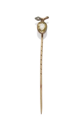 Lot 657 - A Diamond Stick Pin, an old pear cut pale yellow diamond surmounted by a stylised diamond set leaf