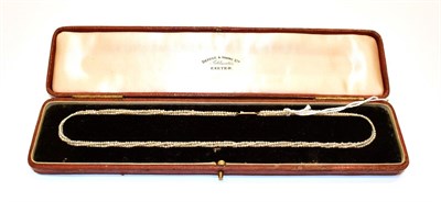 Lot 59 - A seed pearl necklace, circa 1900, three rows of strung seed pearls knotted to a clasp stamped...