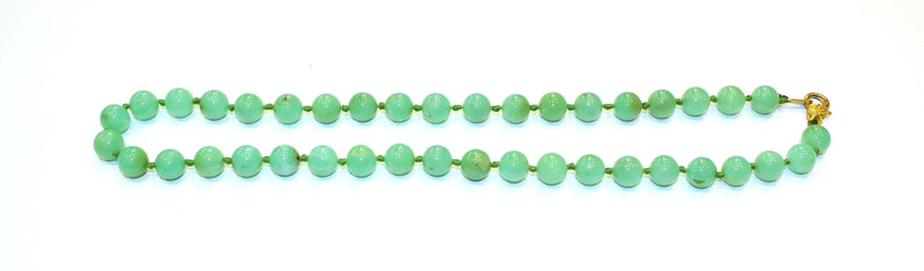Lot 82 - A chalcedony bead necklace, length 53.5cm and a jade pendant, measures 4.1cm by 2.9cm