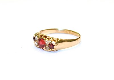 Lot 84 - An 18 carat gold garnet topped doublet and diamond seven stone ring, finger size O