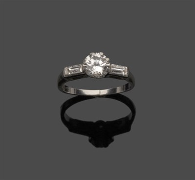 Lot 669 - A Platinum Diamond Ring, a diamond solitaire in a white eight claw setting, with a baguette cut...