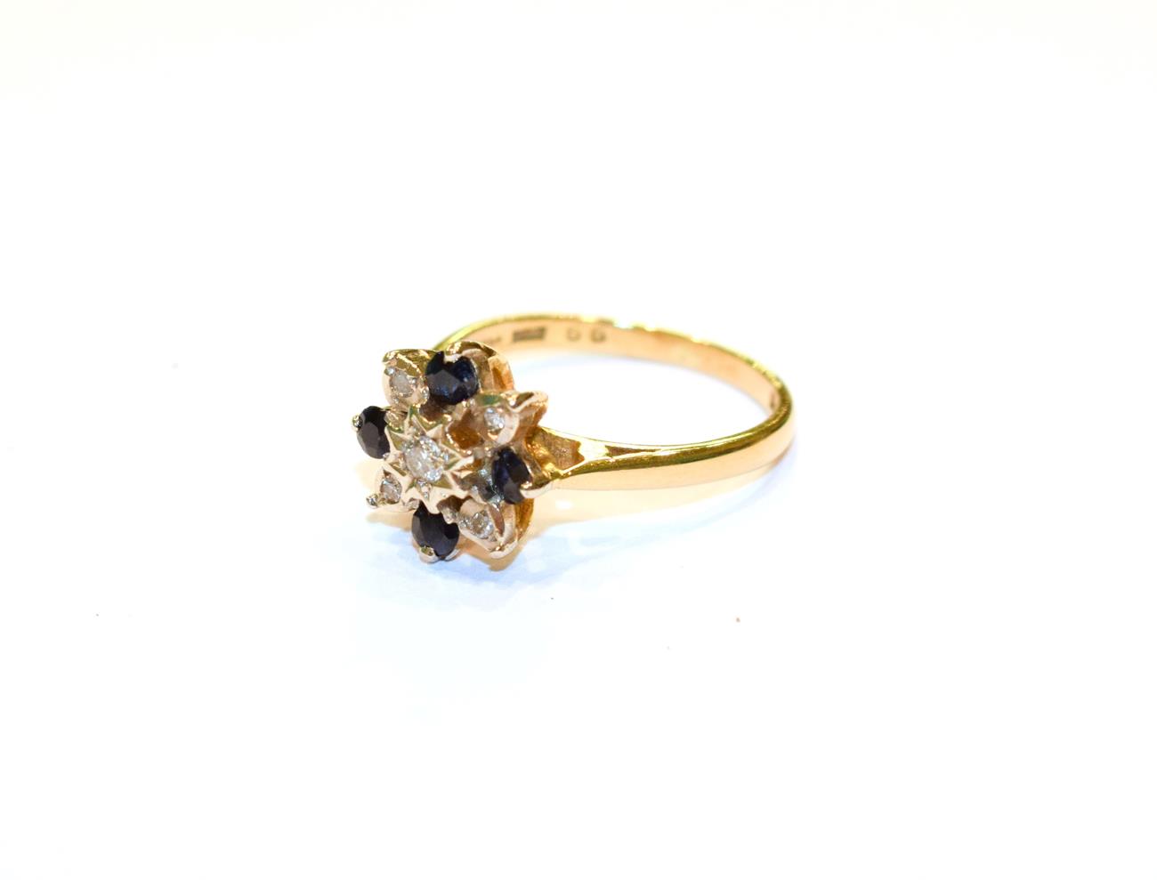 Lot 97 - An 18 carat gold sapphire and diamond cluster ring, finger size L1/2