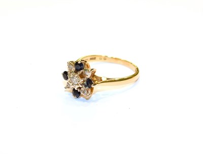 Lot 97 - An 18 carat gold sapphire and diamond cluster ring, finger size L1/2