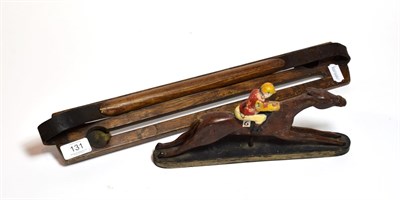 Lot 131 - A game carrier and a cast metal painted model of a racehorse and jockey with paper label