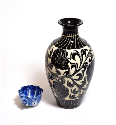 Lot 136 - A Chinese Tz'u chou style vase and a small Chinese blue and white leaf form cup (2)