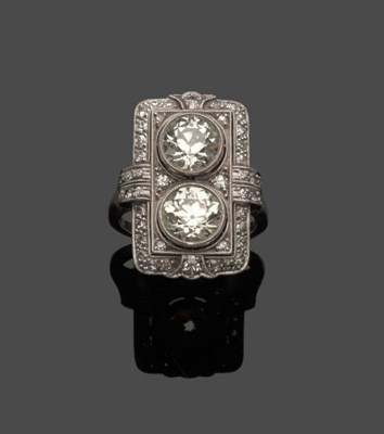 Lot 674 - A French Art Deco Ring, two old brilliant cut diamonds in an oblong diamond set surround, in...