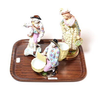 Lot 171 - A Meissen figure of a man seated flanked by two baskets, together with two other continental...