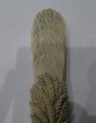 Lot 186 - A carved ivory fan, circa 1900, each section carved at the tip as a feather, the ends carved...