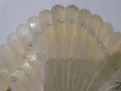 Lot 186 - A carved ivory fan, circa 1900, each section carved at the tip as a feather, the ends carved...