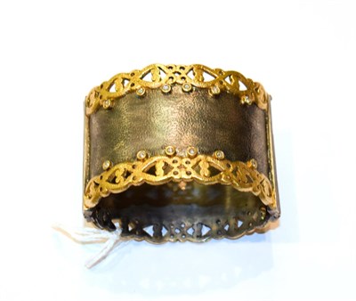 Lot 194 - A silver, gilt and diamond hinged bangle
