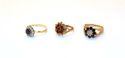 Lot 202 - An 18 carat gold sapphire and diamond cluster ring, finger size M, a 9 carat gold sapphire and...