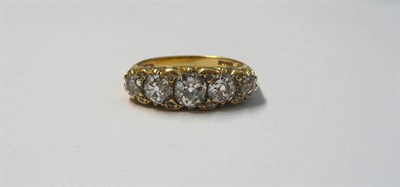 Lot 682 - An 18 Carat Gold Diamond Five Stone Ring, graduated old cut diamonds spaced by pairs of tiny...