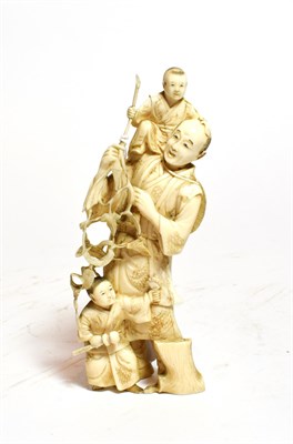 Lot 240 - A Japanese carved ivory figure, late 19th century, carved as a figure supporting a child and...