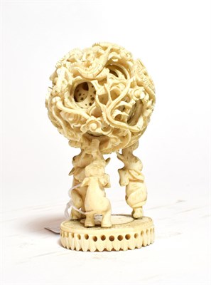 Lot 252 - An early 20th century ivory puzzle ball raised on elephant stand