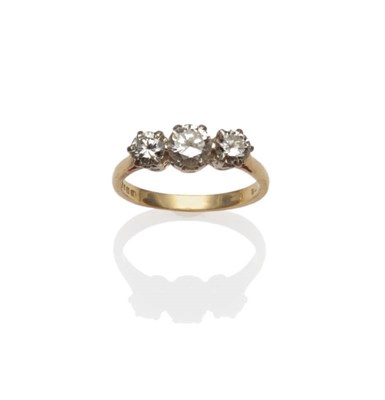 Lot 685 - An 18 Carat Gold Diamond Three Stone Ring, the graduated round brilliant cut diamonds in white claw