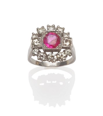 Lot 687 - A Ruby and Diamond Cluster Ring, a round brilliant cut ruby flanked by a round brilliant cut...