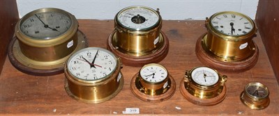 Lot 319 - Five ships type bulk head wall timepieces and two ships type bulk head aneroid barometers (7)