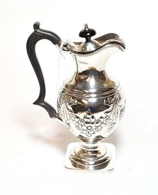 Lot 350 - A Victorian silver hot water jug, Chester, 1899, baluster and on square base, the sides chased with