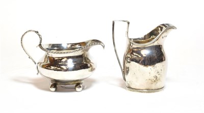 Lot 359 - A George III silver cream jug, by Samuel and Edward Davenport, London, 1795, helmet shaped and with