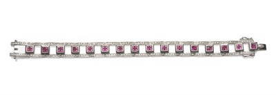 Lot 696 - An 18 Carat White Gold Ruby and Diamond Bracelet, square panels of tension set step-cut rubies,...