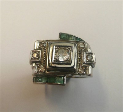 Lot 697 - A Diamond and Emerald Cluster Ring, of geometric form, the diamond in white claw settings, the...