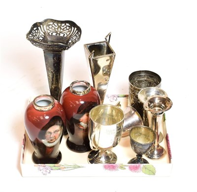 Lot 379 - A collection of assorted silver vases and cups, including a pair of silver-mounted ceramic...