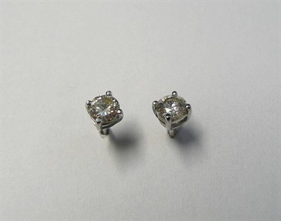 Lot 699 - A Pair of 18 Carat White Gold Diamond Solitaire Stud Earrings, the round brilliant cut diamonds...