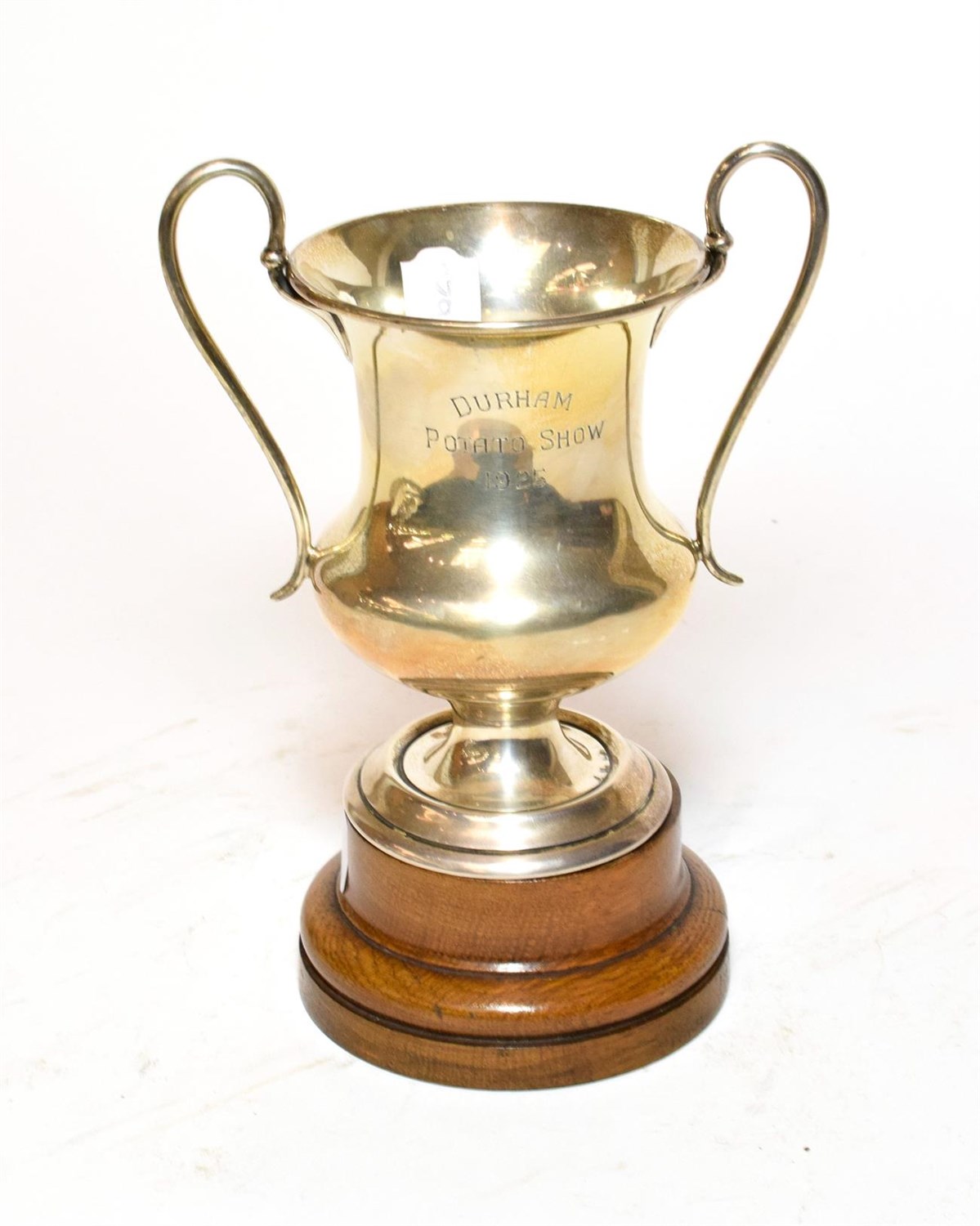 Lot 396 - A George V silver trophy, London, 1923, baluster and on spreading foot with two scroll handles,...