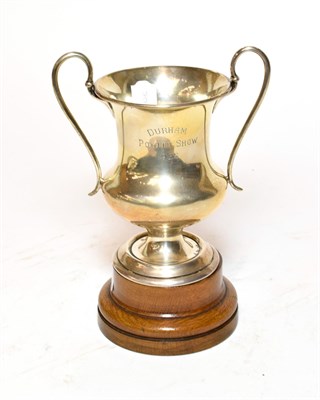 Lot 396 - A George V silver trophy, London, 1923, baluster and on spreading foot with two scroll handles,...