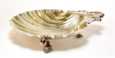 Lot 398 - An Italian silver shell shaped dish, 800 standard, 20th century, on three stylised dolphin feet and