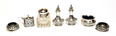 Lot 407 - A quantity of condiment items, including: a pair of part-fluted pepperettes and salt-cellar en...