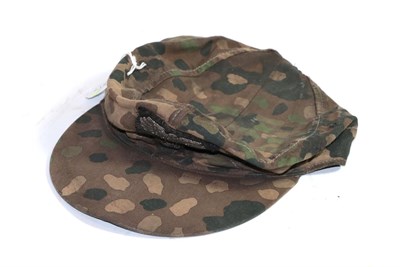 Lot 411 - A copy of a German Third Reich SS camouflage field cap, of herringbone twill, the exterior with...