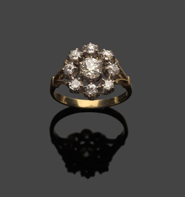 Lot 707 - A Diamond Cluster Ring, an old cut diamond centres a circle of eight smaller diamonds, in white...