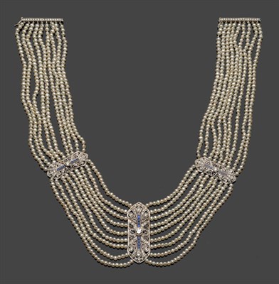 Lot 708 - A Cultured Pearl Choker, nine rows of pearls strung with graduating panels at intervals of diamonds