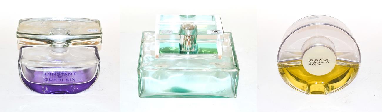 Lot 486 - Glass dummy factice scent bottles comprising Paradoxe de Cardin, Guerlain and another of...