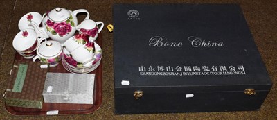 Lot 494 - A cased Jinyuan bone china tea set comprising tea pot, cream jug, sugar bowl, six tea cups and...