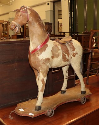 Lot 497 - A Victorian leather, horse hair and wood pull along toy horse, approximately 68.5cm high by...