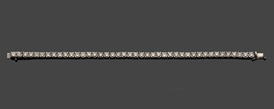 Lot 710 - A Diamond Line Bracelet, the round brilliant cut diamonds held in white claw settings, total...